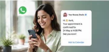 Client smiling at her phone after receiving a WhatsApp confirmation from a beauty studio for her appointment on 24 May at 4 PM